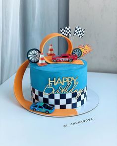 a blue birthday cake with cars on it