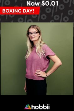 a woman wearing glasses standing in front of a green wall with her hands on her hips