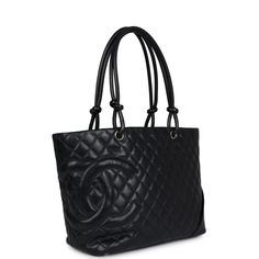 This vintage Chanel large Cambon Ligne tote in black calfskin and patent leather with silver tone hardware, features a quilted leather shopping tote, a large patent leather CC logo on the side of the tote, half moon back exterior pocket, two knotted leather rope top handles, and a zipper top closure with silver tone logo pull.The interior is lined in a pink CC Monogram Satin Fabric and has two interior zip pockets on both sizes, one open phone pocket, and two lipstick/pen pocket holders.Collecti Cc Monogram, Usa Government, Pink Cc, Vintage Chanel Bag, Vintage Tote Bag, Chanel Tote, Chanel Bags