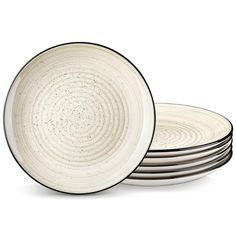 four black and white plates stacked on top of each other