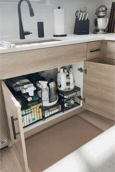 an open cabinet in a kitchen with dishes and condiments