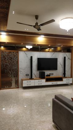 a living room filled with furniture and a flat screen tv on top of a wooden entertainment center