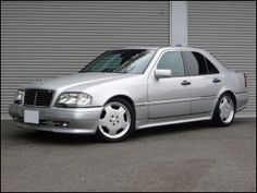 a silver car parked in front of a garage door