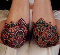 the legs are decorated with colorful tattoos on them