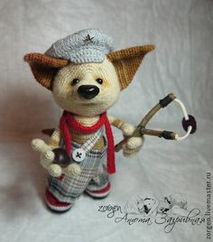 a small stuffed animal with a hat, scarf and boots is holding a wrench