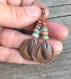 Antiqued copper discs with a small feather drop accent and African opals. Very light weight and perfect colors for your fall wardrobe! Approx 2" in total hanging length. Rust Colored Bohemian Metal Jewelry, Bohemian Rust-colored Metal Jewelry, Rust Copper Dangle Earrings, Nickel-free Rust Drop Earrings, Rust Colored Copper Dangle Jewelry, Rust Copper Dangle Jewelry, Rust-colored Copper Dangle Jewelry, Rust-colored Bohemian Copper Jewelry, Bohemian Rust-colored Copper Jewelry