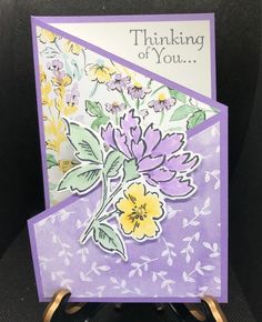 a purple card with yellow and white flowers on it that says, thinking of you