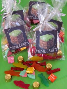 three bags filled with assorted candy on top of a green table covered in gummy bears