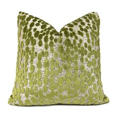 a green and white pillow on a white background