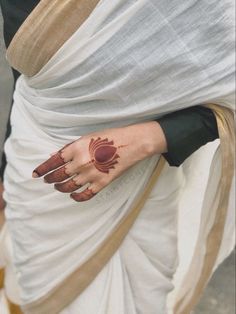 a woman's hand with henna on her left arm and palm print on it