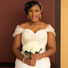 a woman in a wedding dress holding a bouquet