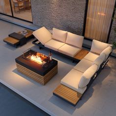 an outdoor living area with couches and fire pit