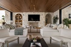 a living room filled with furniture and a flat screen tv mounted to the wall over a fireplace