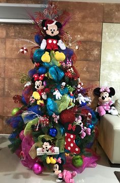 a christmas tree with mickey mouse decorations on it