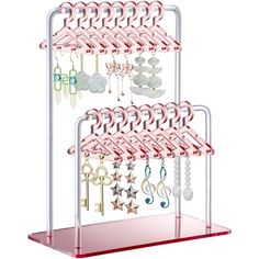 a rack with several pairs of earrings hanging from it's sides and two rows of keys attached to them