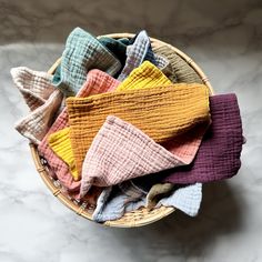 a basket filled with lots of different colored socks on top of a table next to a white counter