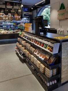 the inside of a grocery store filled with lots of food and drinks on shelves next to a cash register