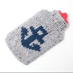 a knitted pouch sitting on top of a white table