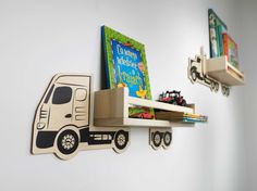 two children's bookshelves on the wall with trucks and cars painted on them