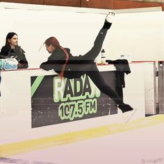 two people are skating on an ice rink