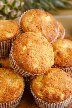 a pile of muffins sitting on top of a wooden table