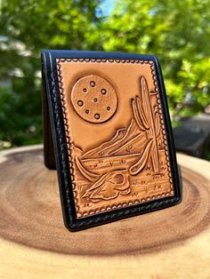 a leather wallet sitting on top of a tree stump