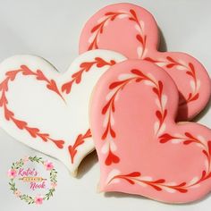 two heart shaped cookies sitting next to each other