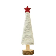 a small white christmas tree with a red star on it's top sitting on a wooden stand