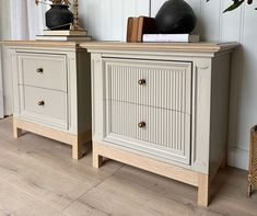 two white dressers sitting next to each other on top of a hard wood floor