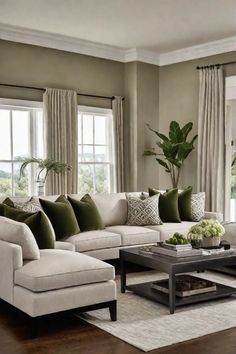 a living room filled with lots of furniture next to a window covered in green and white pillows