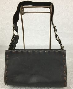 "Here we have a vintage brown leather footed Purse with a wide strap, metal studs and large buckle. This has a great retro look. This is in very nice condition considering its age. I noticed some light scratches but no ther problems. It measures: Height - 6\" Width - 9 3/4\" Depth - 4 1/4\" Strap Drop - 11 1/4\" I try my best to give accurate descriptions, although I am no expert, plus I'm human and sometimes I might miss a flaw. I always provide high resolution photos and consider them to be pa Vintage Leather Bags With Metal Hardware, Rectangular Leather Bag With Rivets, Vintage Brown Faux Leather Shoulder Bag, Leather Satchel Shoulder Bag With Rivets, Vintage Brown Faux Leather Satchel, Retro Leather Shoulder Bag With Metal Hardware, Brown Leather Shoulder Bag With Buckle Closure, Brown Leather Bags With Rivets, Leather Shoulder Bag With Rivets For Daily Use