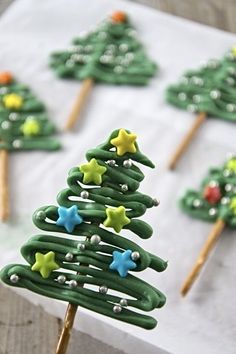 green christmas tree shaped cookies on top of a white paper towel with wooden skewers