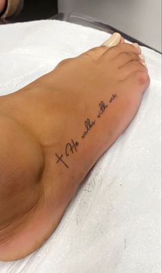 a person with a cross tattoo on their foot