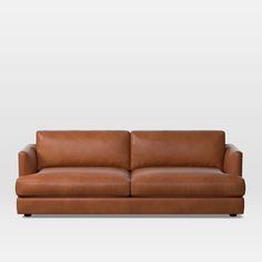 a brown leather couch against a white background