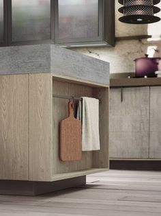 an open cabinet with cutting board and knife on it in the middle of a kitchen