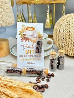 a table topped with lots of bottles filled with coffee beans and some cards on top of it