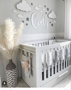 a baby's room decorated in white and gray