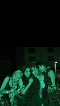 group of girls standing together in the dark