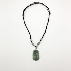 This is a high grade jadeite jade pendant necklace. It is exquisitely hand carved, so each pendant is different in some way. The pendant is completely natural jade, un-dyed and in its natural form. The pendant is carved in the form of the Chinese Zodiac - Dog. The beads above the pendant on the necklace are natural hand carved jadeite jade beads. They may not be perfectly round because they are hand carved. This gives the necklace a more rustic and natural stone like look. The years of the Dog i Traditional Engraved Jade Necklace, Engraved Jade Amulet Jewelry, Adjustable Jade Necklace, Carved Jade Pendant Jewelry, Spiritual Engraved Jade Necklace, Carved Jade Pendant Necklace, Dog Chinese Zodiac, Jade Pendant Necklace, Carved Pendant