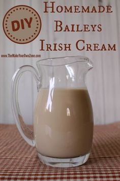 homemade bailey's irish cream in a glass pitcher on a checkered tablecloth