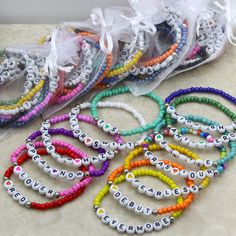 several bracelets with words on them sitting on a table next to some organ bags