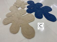 three rugs in the shape of an octopus are on the floor next to each other