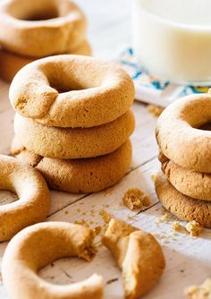 several cookies stacked on top of each other next to a glass of milk