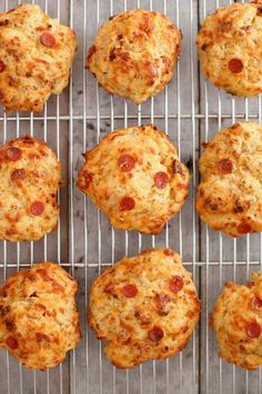 several cheese and pepperoni muffins cooling on a wire rack