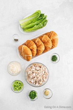 the ingredients are laid out on the table to make this appetizing dish, including green beans and croissants