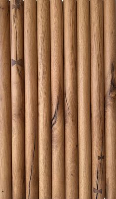 several wooden sticks are lined up against each other in order to be used as wall hangings