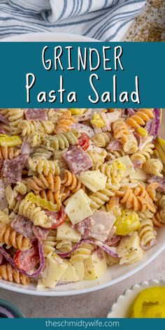 a white bowl filled with pasta salad on top of a table