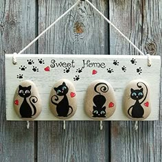 three magnets with cats on them hanging from a wooden sign that says, sweet home