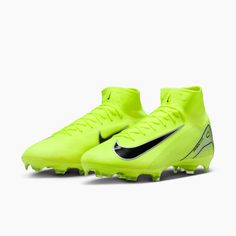 a pair of yellow nike soccer cleats with black and white lettering on the soles