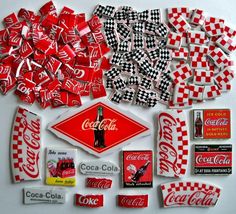 an assortment of coca - cola stickers and decals are displayed on a white surface